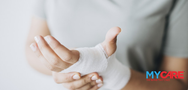 A woman with gauze band wrapped around her hand and wound is not healing